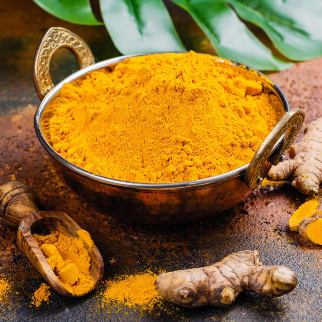High Curcumin Alleppey Turmeric Powder in a brass bowl from Angadi of Spices