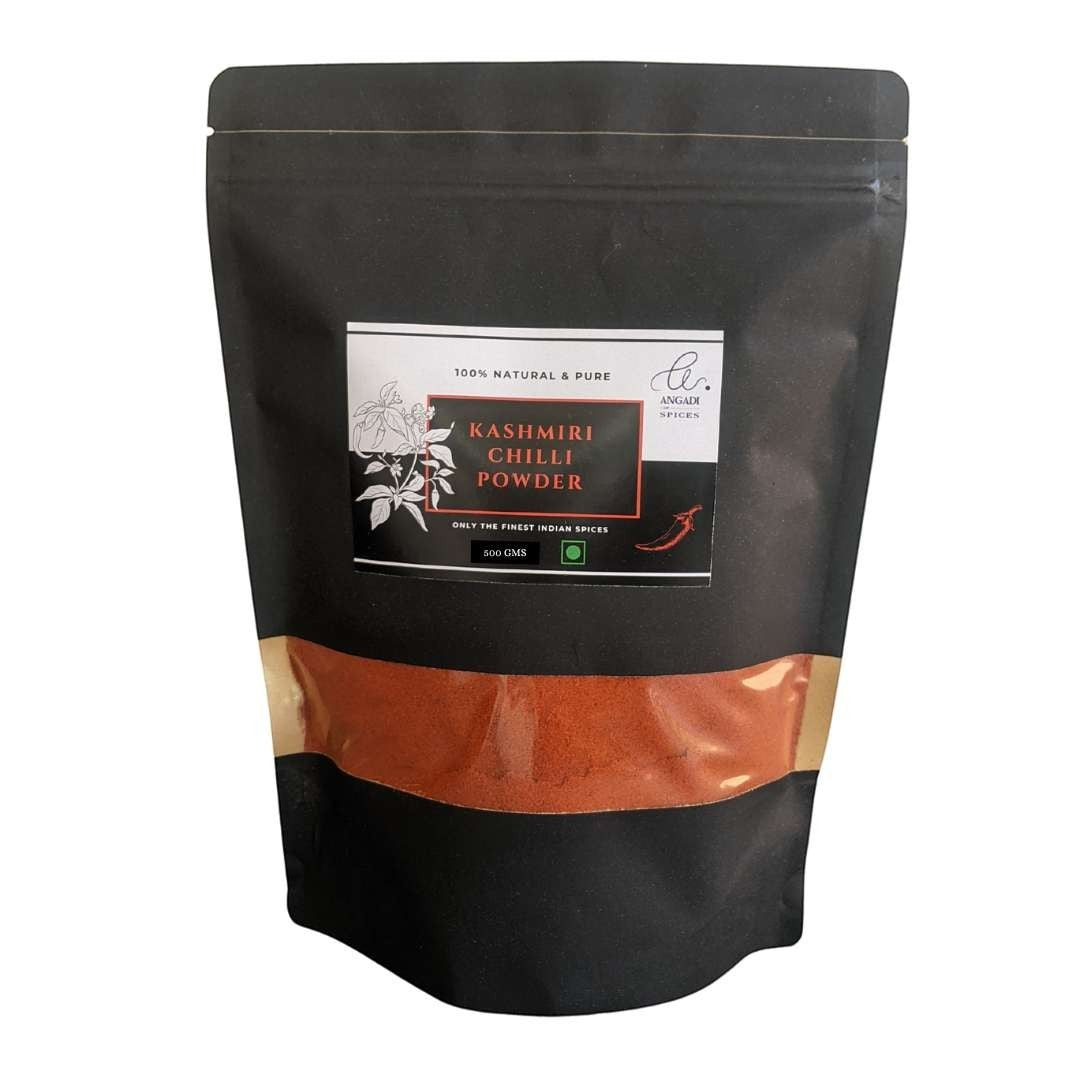 Angadi of Spices Kashmiri Chilli Powder in a black pouch, 500g. Vibrant red powder with minimum pungency, rich in vitamins and iron.