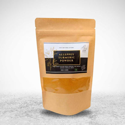 Angadi of Spices Authentic Alleppey Turmeric Powder in a brown resealable pouch with a clear window showing the vibrant yellow powder.