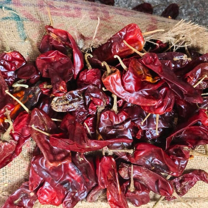 Angadi of Spices Authentic Kashmiri Chilli Powder, vibrant red dried whole chillies with stems, low pungency, rich in vitamins and iron.